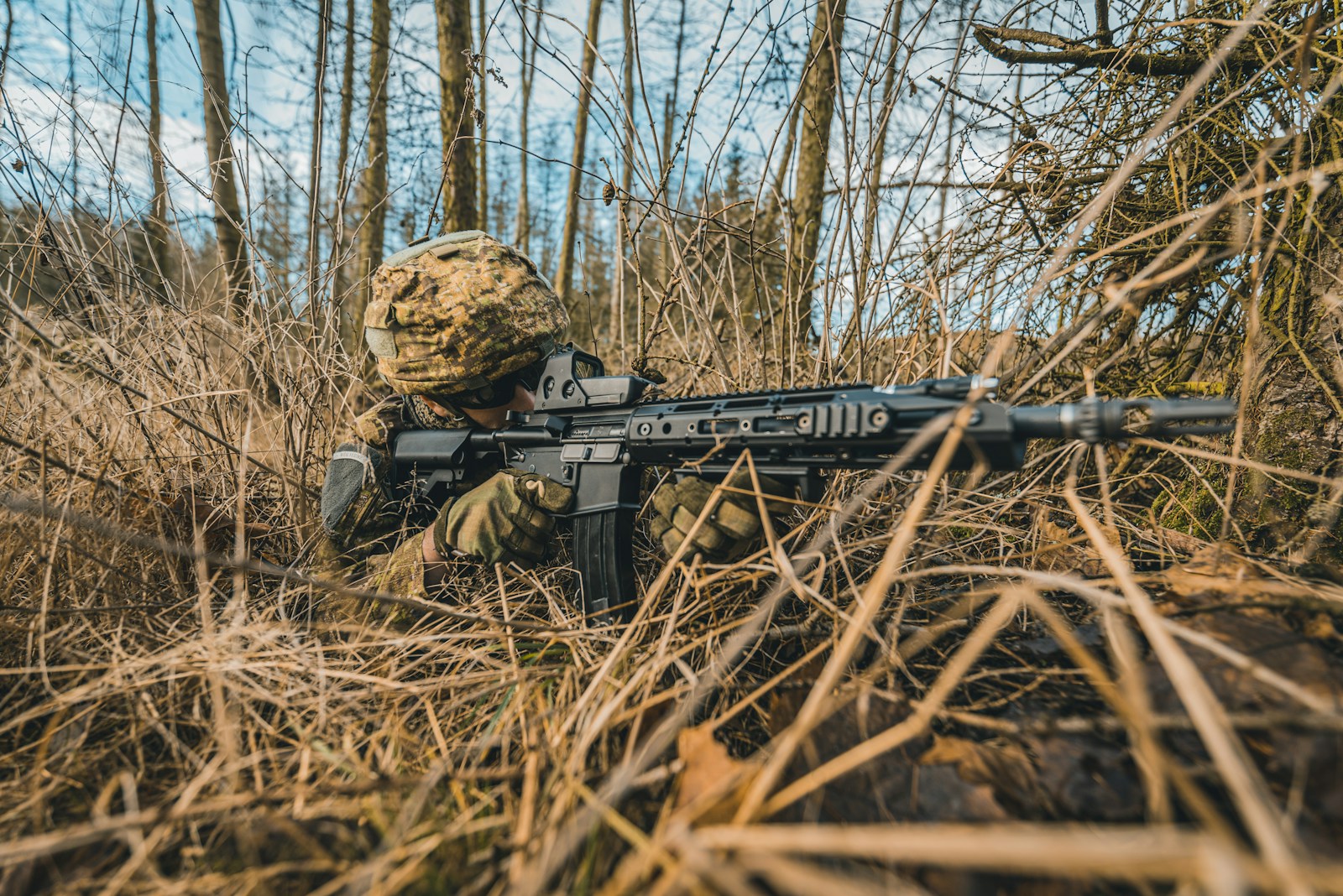 black and brown assault rifle on brown dried leaves